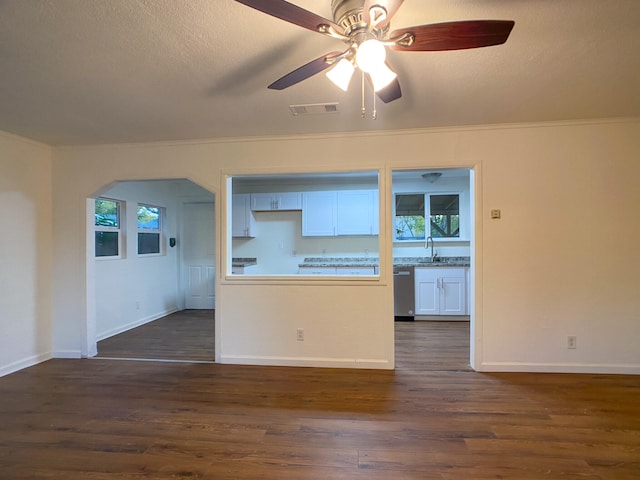 interior space featuring dark hardwood / wood-style flooring, sink, crown molding, and white cabinets