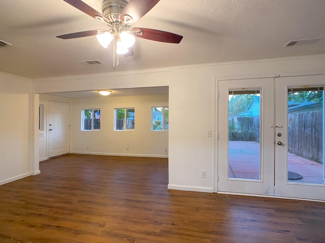 interior space with dark wood-type flooring, ceiling fan, and plenty of natural light