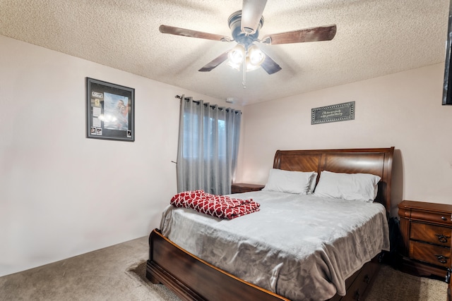 bedroom with ceiling fan, a textured ceiling, and carpet flooring