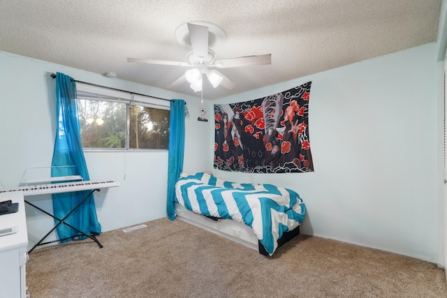 bedroom featuring ceiling fan, carpet floors, and a textured ceiling