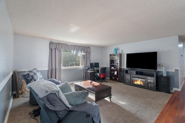 carpeted living room featuring a textured ceiling