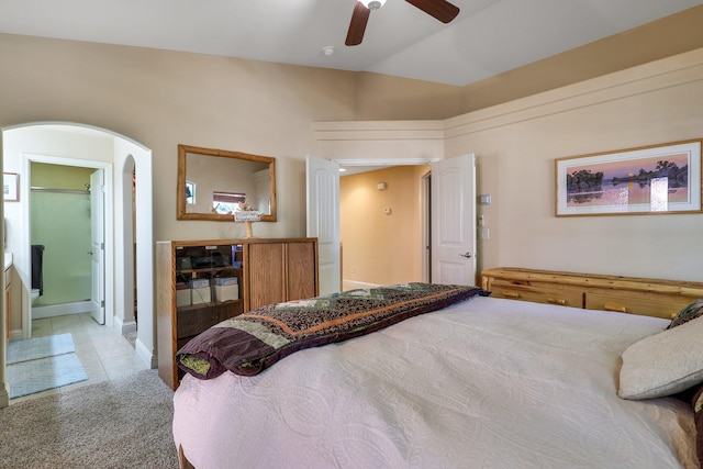bedroom featuring ceiling fan, connected bathroom, and light tile patterned floors