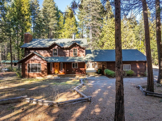 34820 Emigrant Trl, Shingletown, CA 96088 - view of front of house featuring a porch, a chimney, and a shingled roof