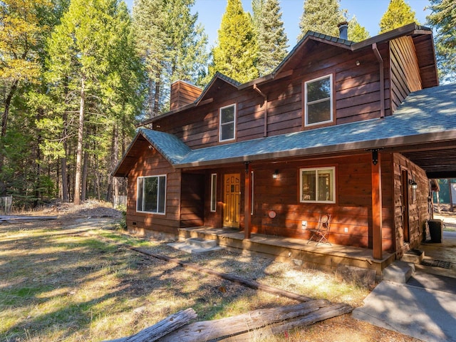 34820 Emigrant Trl, Shingletown, CA 96088 - chalet / cabin featuring a chimney, a porch, and a shingled roof