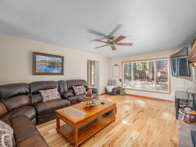 living room featuring light hardwood / wood-style floors and ceiling fan