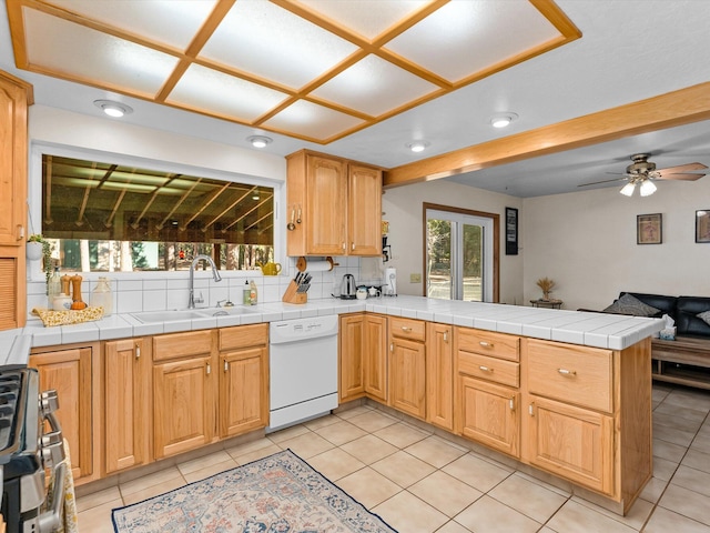 kitchen with tile countertops, sink, kitchen peninsula, tasteful backsplash, and white dishwasher