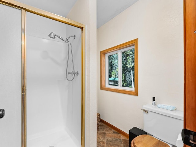 34820 Emigrant Trl, Shingletown, CA 96088 - full bathroom with stone finish flooring, a stall shower, toilet, and baseboards