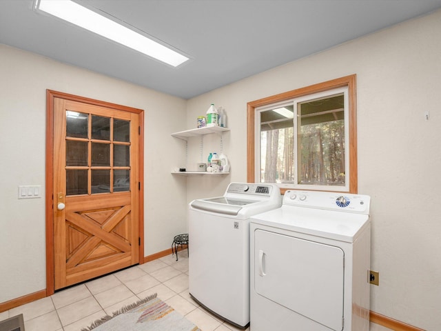 washroom with washing machine and clothes dryer and light tile patterned flooring