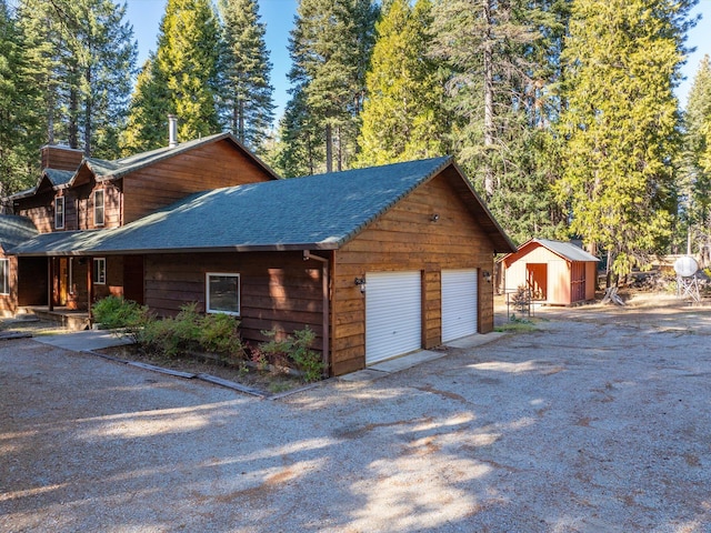 exterior space featuring a shed and a garage