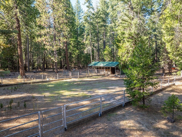 34820 Emigrant Trl, Shingletown, CA 96088 - view of yard featuring an exterior structure, an outdoor structure, and a wooded view