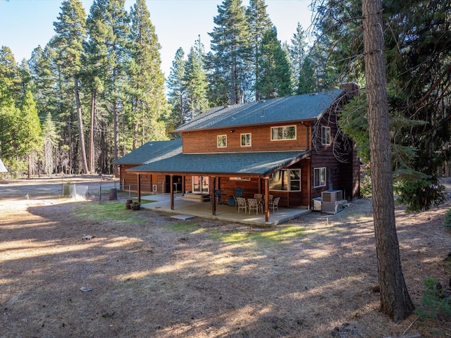 34820 Emigrant Trl, Shingletown, CA 96088 - back of house featuring a shingled roof, a patio area, cooling unit, and fence