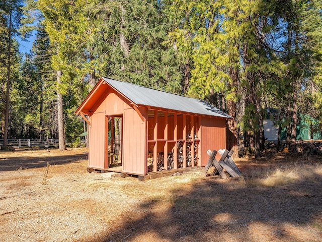 34820 Emigrant Trl, Shingletown, CA 96088 - view of outbuilding with fence, an outdoor structure, and a wooded view