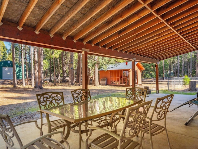 34820 Emigrant Trl, Shingletown, CA 96088 - view of patio featuring outdoor dining area, fence, and an outdoor structure