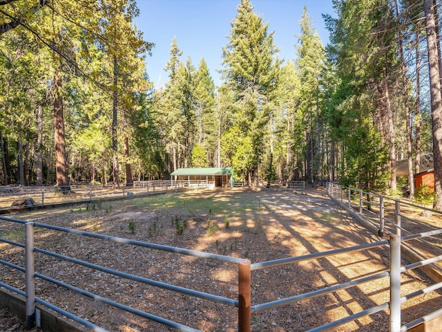 34820 Emigrant Trl, Shingletown, CA 96088 - view of yard featuring an exterior structure, an outbuilding, and a view of trees