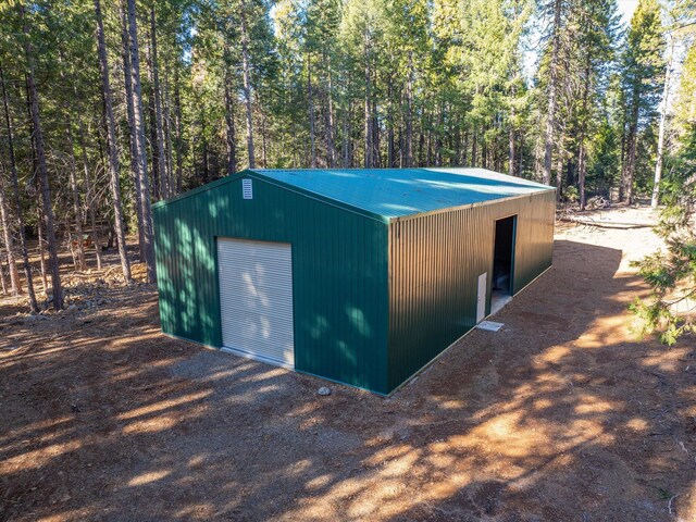 34820 Emigrant Trl, Shingletown, CA 96088 - view of outbuilding featuring a wooded view and an outdoor structure