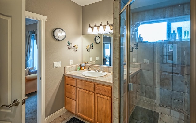 bathroom featuring vanity, tile patterned floors, and a shower with shower door