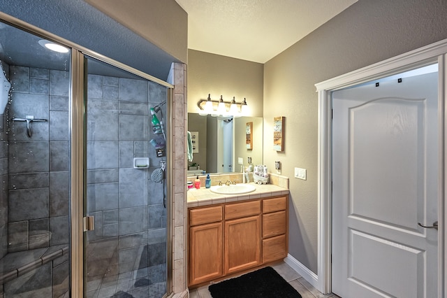 bathroom featuring an enclosed shower, vanity, and tile patterned floors