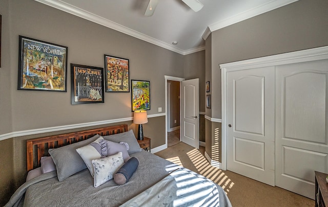 bedroom featuring a closet, ornamental molding, light carpet, lofted ceiling, and ceiling fan