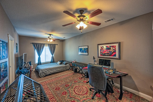 bedroom with a textured ceiling and ceiling fan