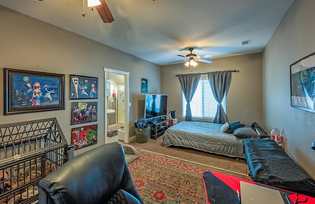 bedroom with carpet floors, ceiling fan, and connected bathroom