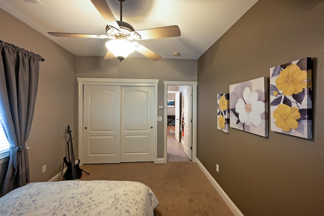 bedroom with light carpet, ceiling fan, and a closet