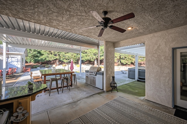 view of patio with ceiling fan, a hot tub, and grilling area