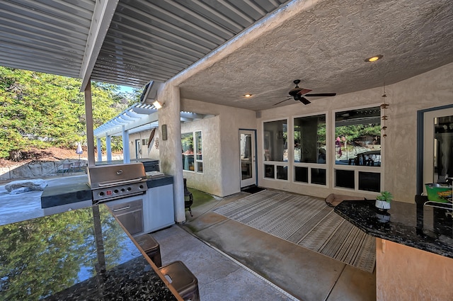 view of patio / terrace featuring grilling area, ceiling fan, a pergola, and exterior kitchen