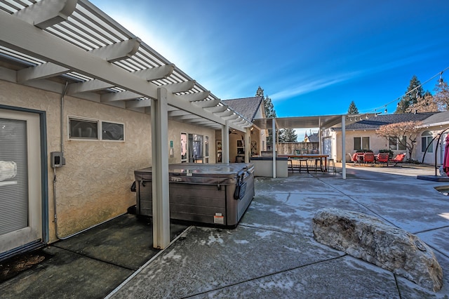 view of patio featuring a hot tub and a pergola