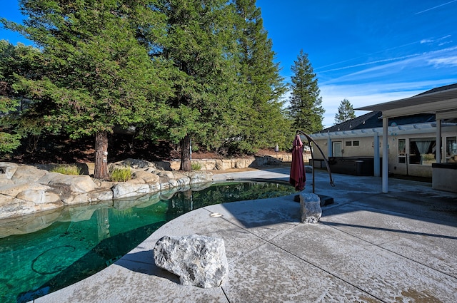 exterior space featuring a swimming pool with hot tub