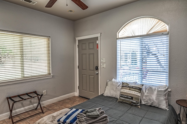 tiled bedroom with ceiling fan