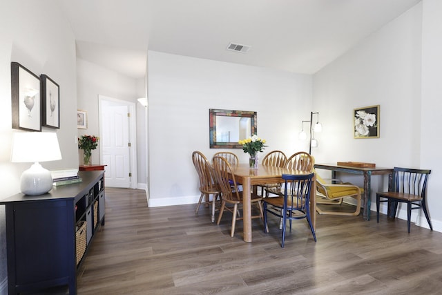 dining space with dark hardwood / wood-style flooring