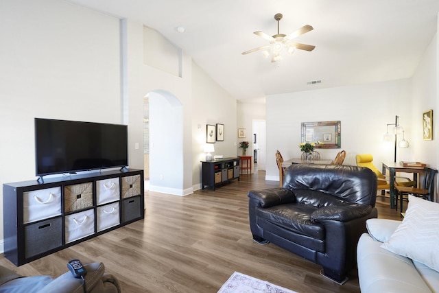 living room with hardwood / wood-style flooring, high vaulted ceiling, and ceiling fan