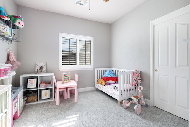 bedroom with carpet flooring and a crib