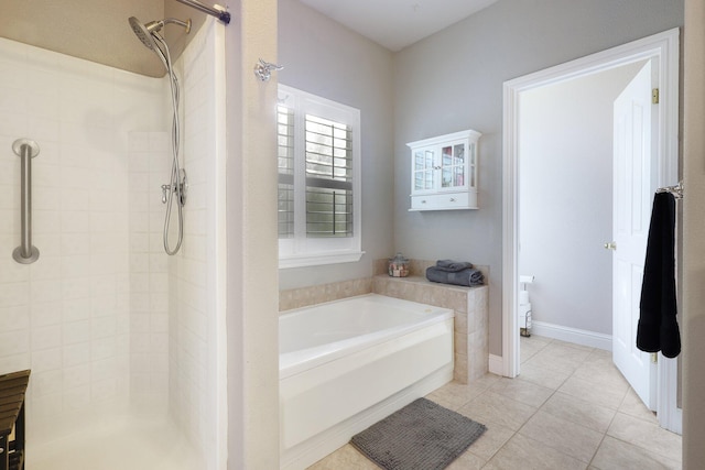 bathroom featuring tile patterned flooring and independent shower and bath