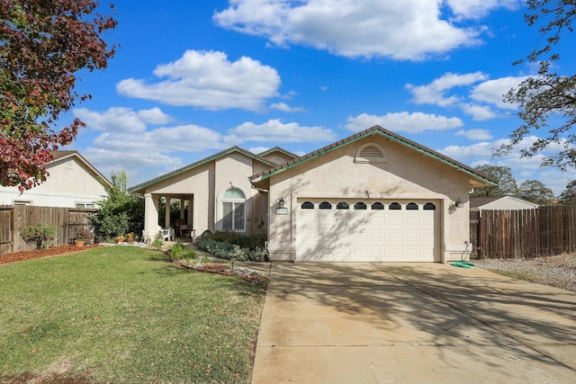 view of front of home with a garage and a front lawn