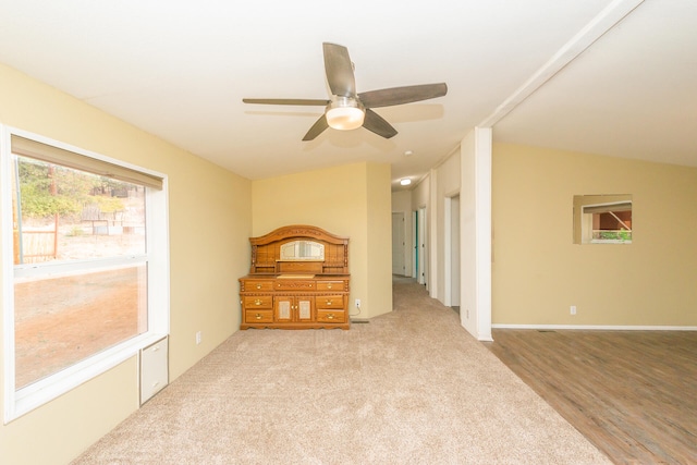 interior space featuring ceiling fan, light hardwood / wood-style flooring, and vaulted ceiling