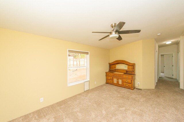 empty room featuring light carpet and ceiling fan