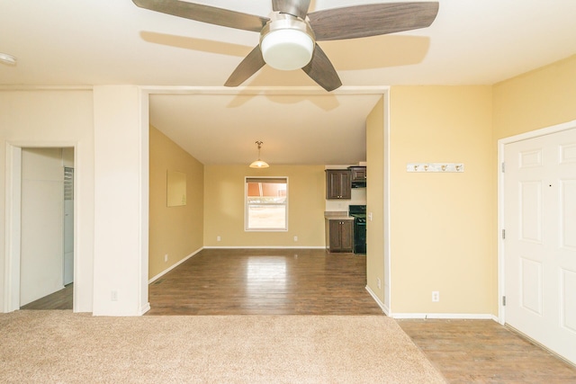 unfurnished living room featuring wood-type flooring and ceiling fan