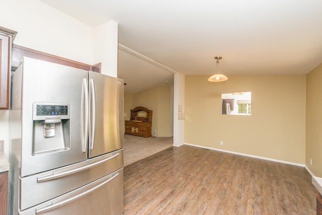 kitchen with hardwood / wood-style flooring, stainless steel fridge with ice dispenser, and stainless steel refrigerator