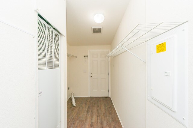 spacious closet featuring dark hardwood / wood-style flooring