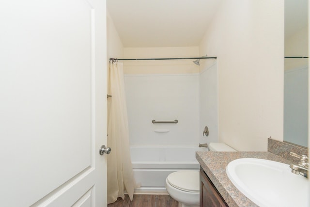 full bathroom featuring vanity, hardwood / wood-style flooring, toilet, and shower / tub combo