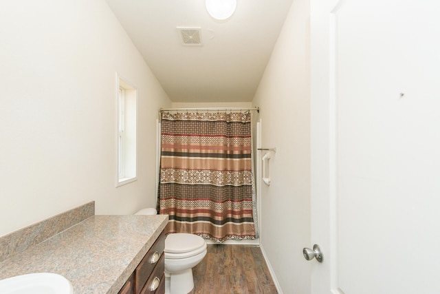 bathroom with wood-type flooring, vanity, curtained shower, toilet, and lofted ceiling