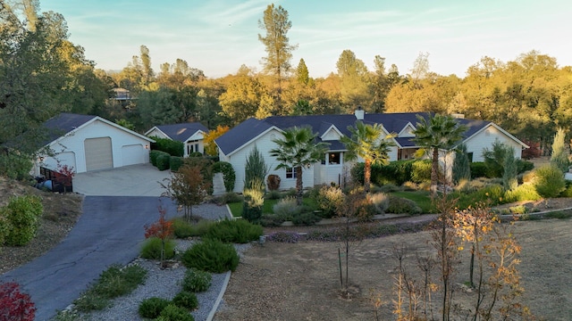 ranch-style house with a garage and an outdoor structure