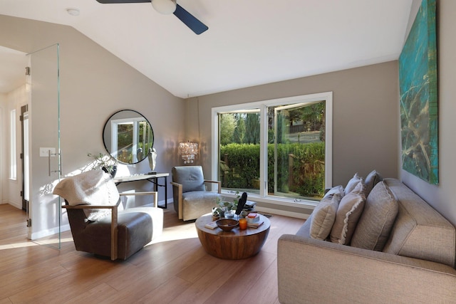 living room with ceiling fan, wood-type flooring, and lofted ceiling