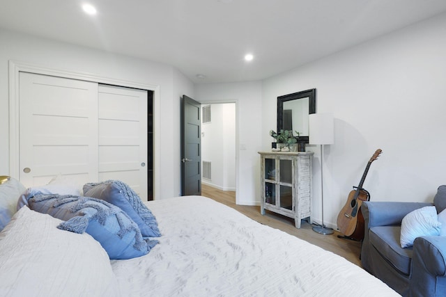 bedroom featuring wood-type flooring and a closet