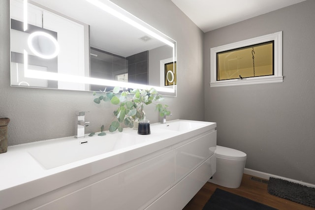 bathroom featuring hardwood / wood-style floors, vanity, and toilet