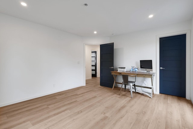 office area with light hardwood / wood-style floors