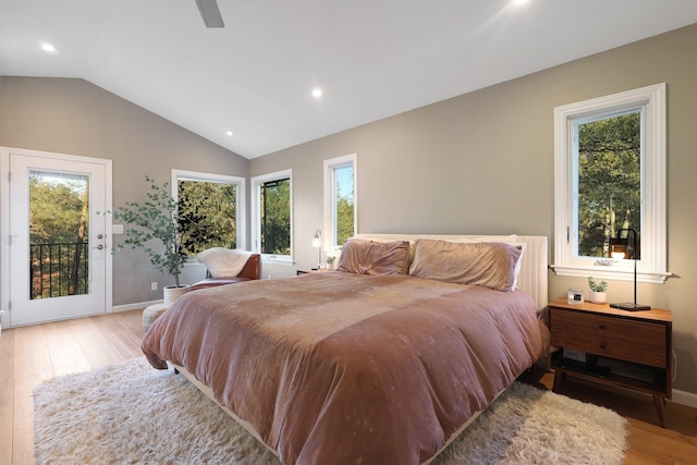 bedroom with access to exterior, multiple windows, and light hardwood / wood-style flooring