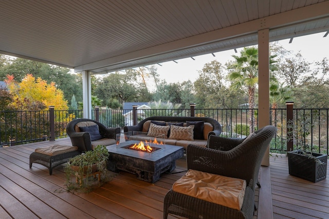 wooden deck with an outdoor living space with a fire pit