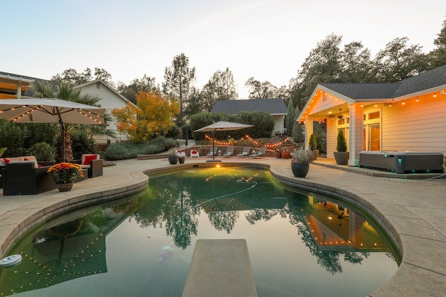 view of swimming pool featuring central air condition unit and a patio